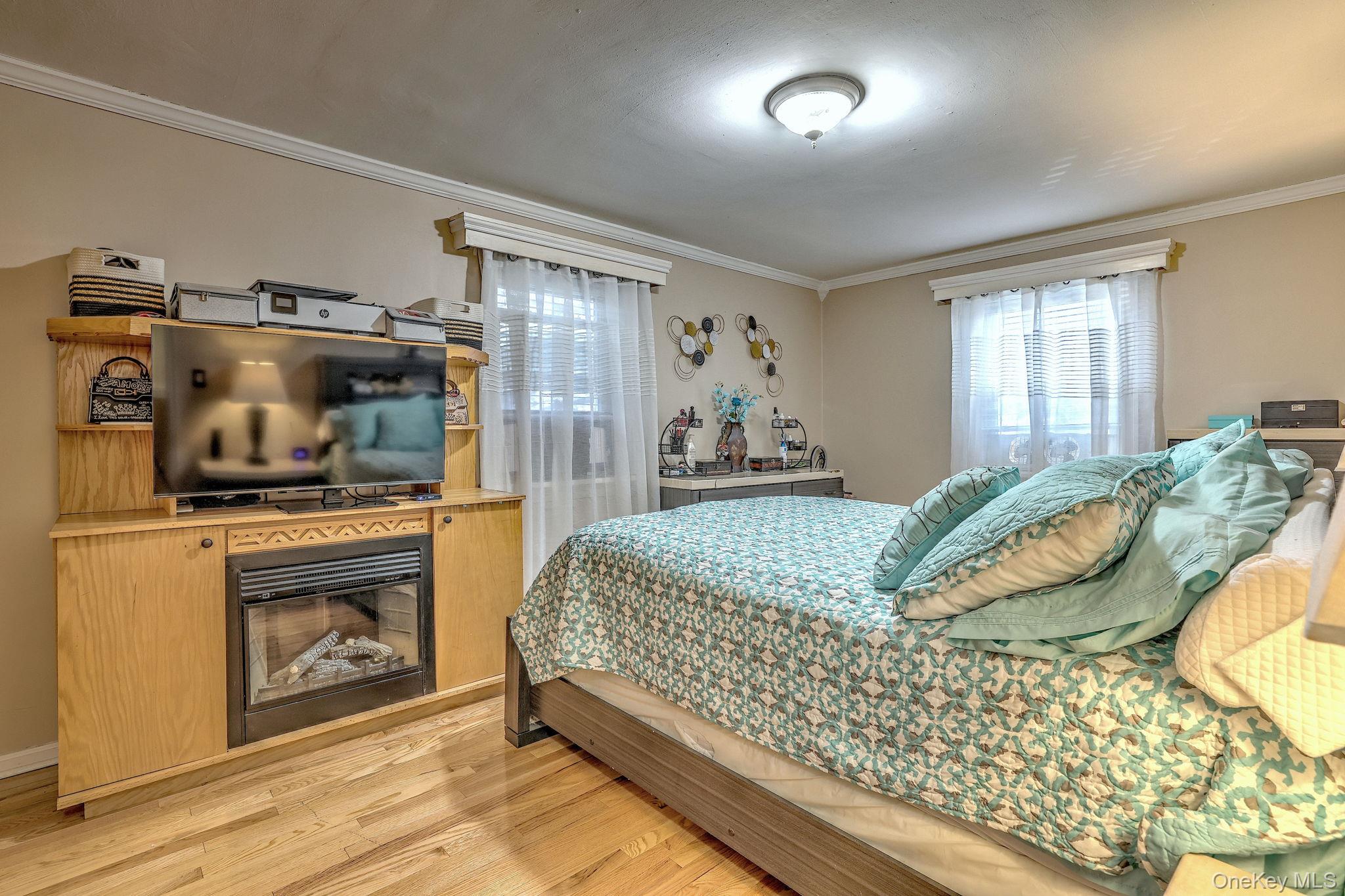 450 Pelham Road, Unit 3B New Rochelle, NY 10805 - Photo 13 of 19 a bedroom with a bed and wooden floor