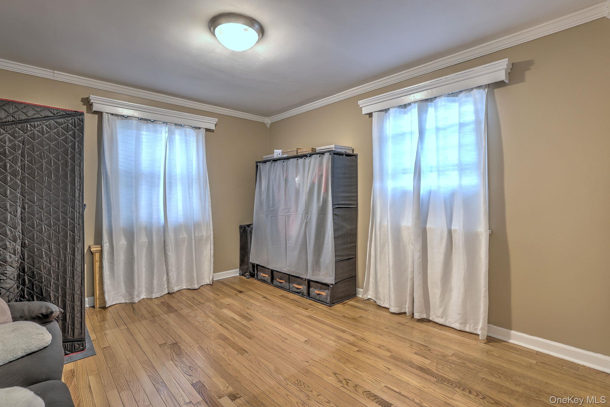 450 Pelham Road, Unit 3B New Rochelle, NY 10805 - Photo 14 of 19 wooden floor and windows in an empty room