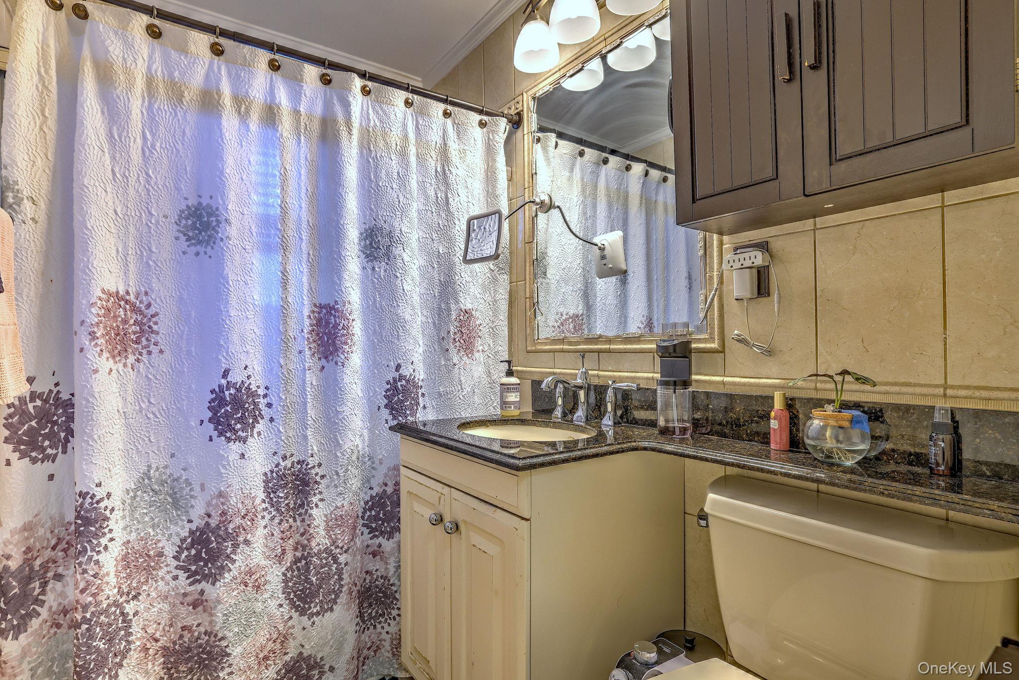 450 Pelham Road, Unit 3B New Rochelle, NY 10805 - Photo 15 of 19 a bathroom with a granite countertop sink and a mirror