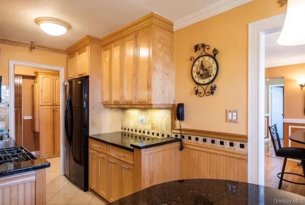 a kitchen with stainless steel appliances granite countertop a stove and a refrigerator