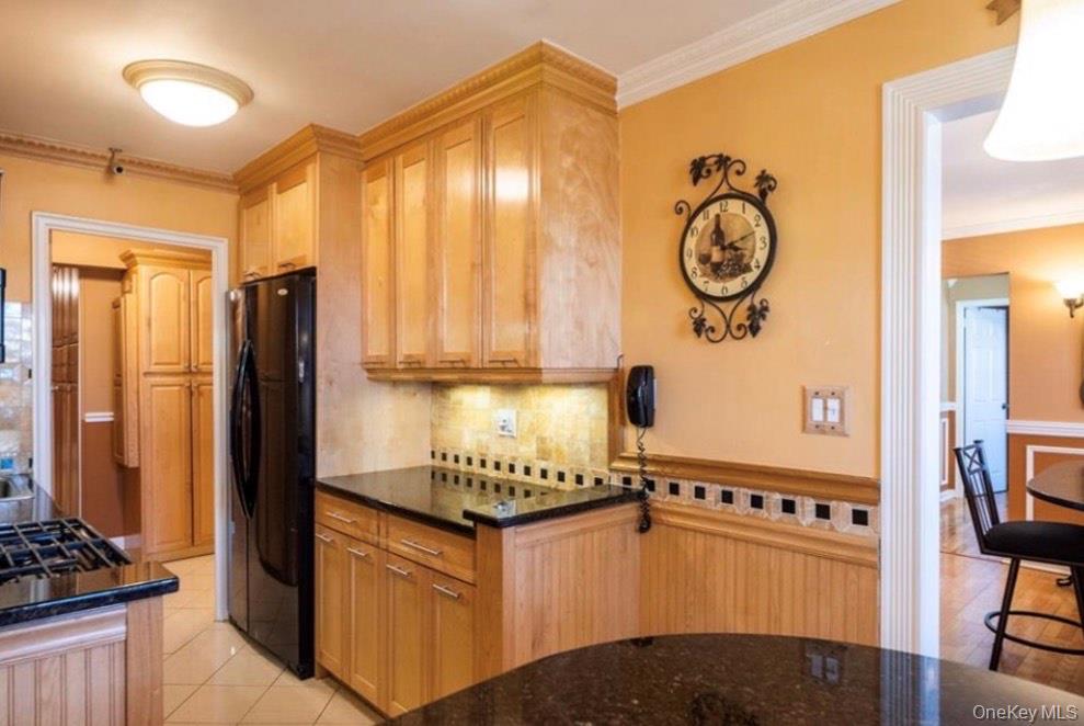 450 Pelham Road, Unit 3B New Rochelle, NY 10805 - Photo 6 of 19 a kitchen with stainless steel appliances granite countertop a stove and a refrigerator