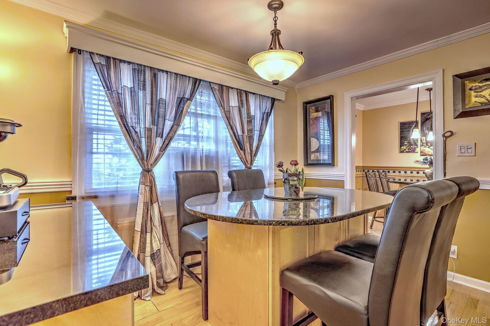 450 Pelham Road, Unit 3B New Rochelle, NY 10805 - Photo 9 of 19 a view of a dining room with furniture wooden floor and chandelier