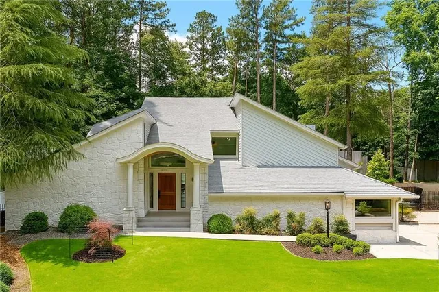 a front view of a house with garden