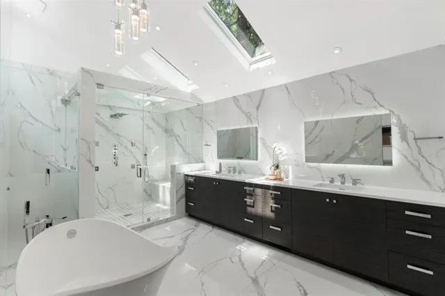 a large bathroom with a double vanity sink mirror and bathtub