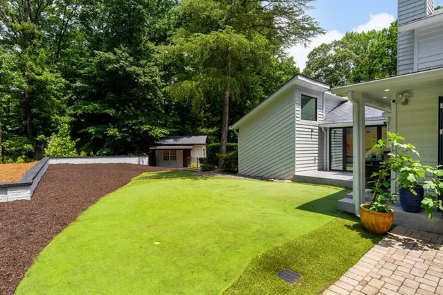 a view of house with backyard and swimming pool