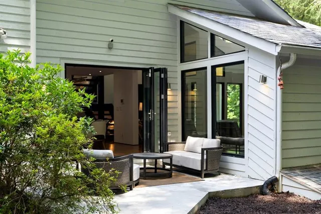 a front view of a house with a yard and trees