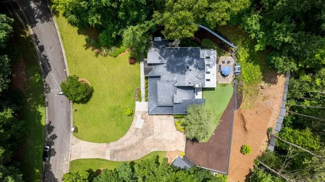 an aerial view of a house with swimming pool and garden space