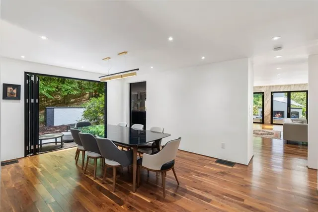 a dining room with furniture and wooden floor