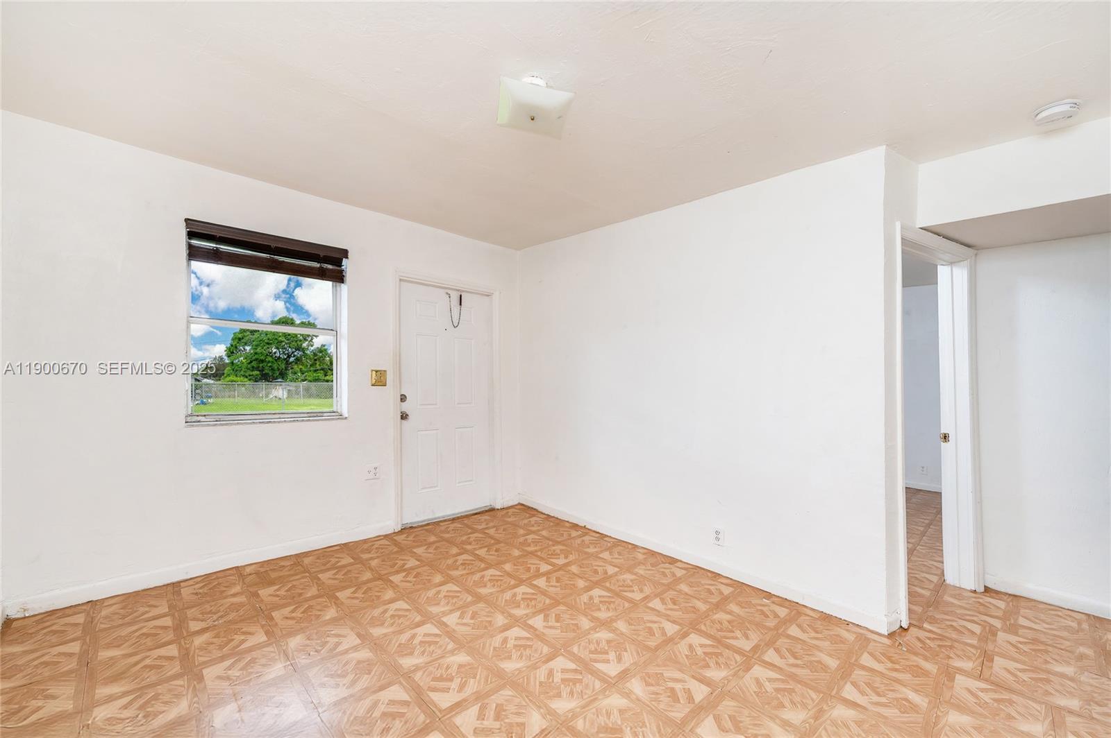 10015 Southwest 170th Terrace, Unit 2 Miami, FL 33157 - Photo 14 of 26 a view of a bedroom with wooden floor and window