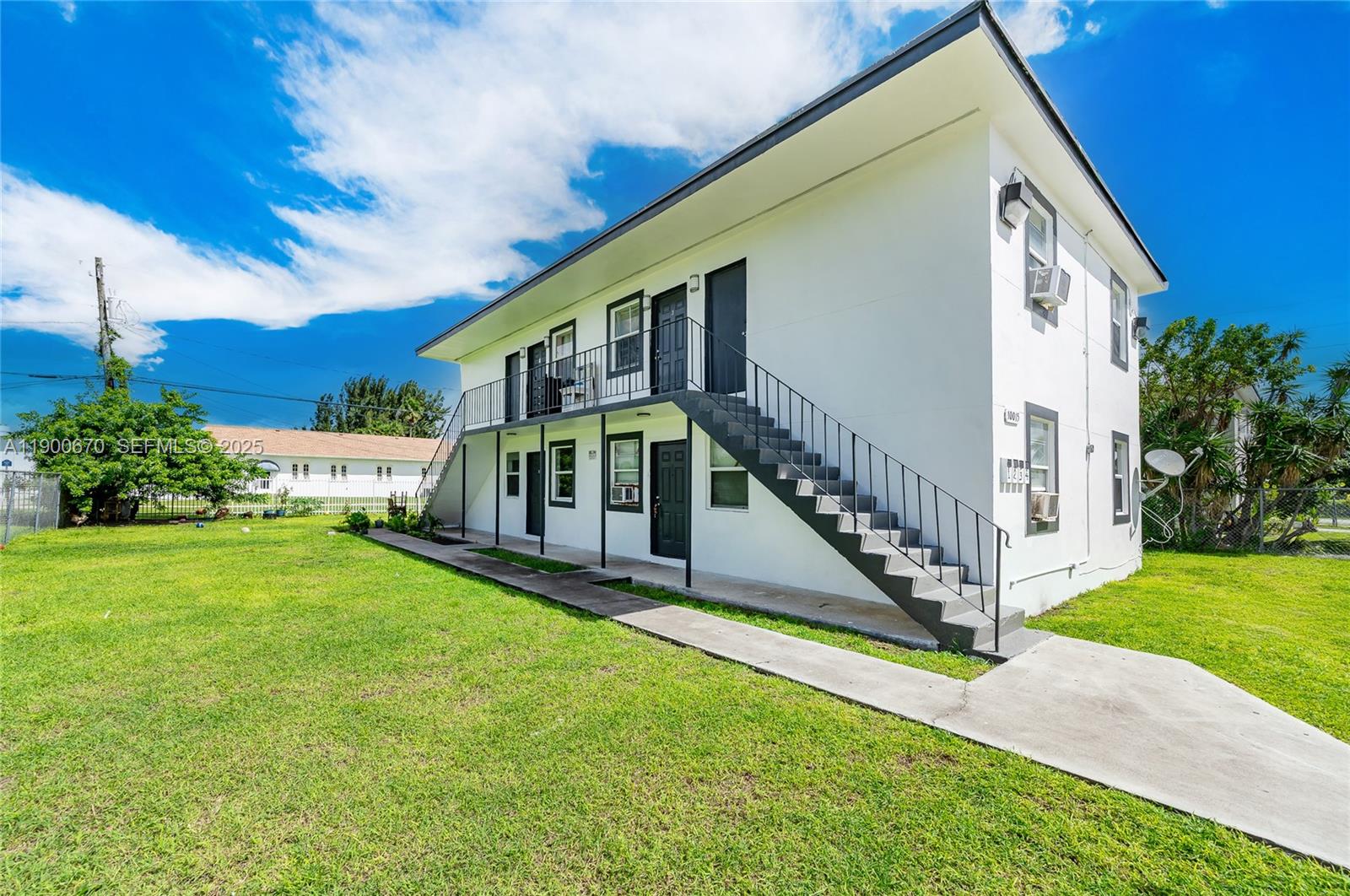 10015 Southwest 170th Terrace, Unit 2 Miami, FL 33157 - Photo 2 of 26 a view of house with a yard