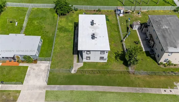 a aerial view of multiple houses with yard