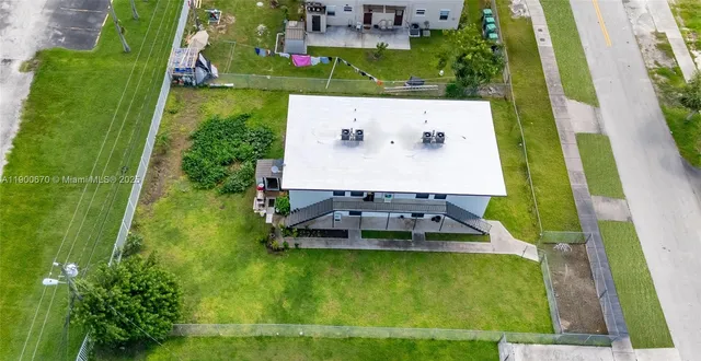 an aerial view of residential houses with outdoor space