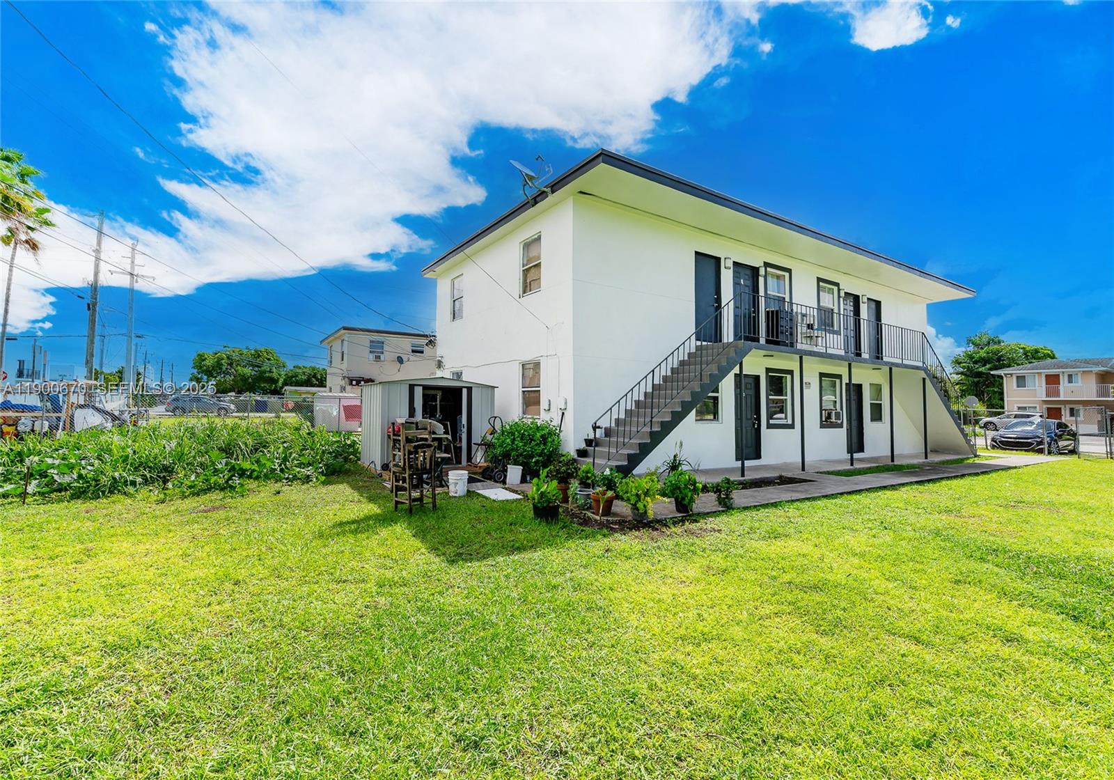 10015 Southwest 170th Terrace, Unit 2 Miami, FL 33157 - Photo 3 of 26 a view of a house with a yard porch and sitting area