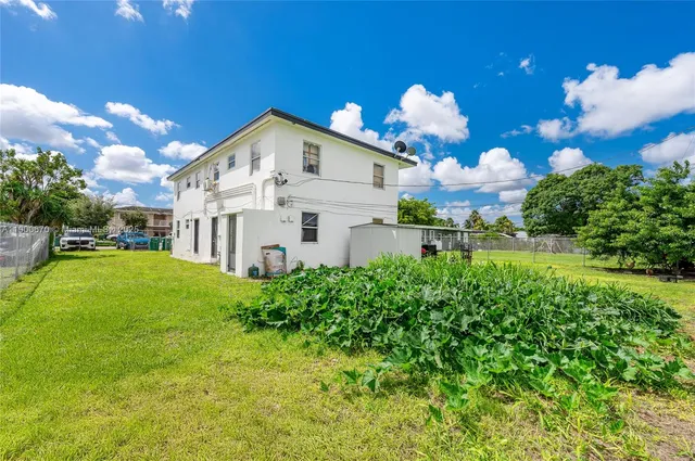 a view of a house with a yard and garden