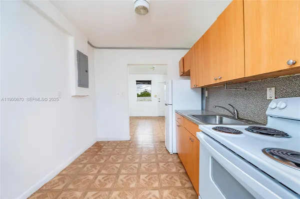 a kitchen with a sink and a stove top oven