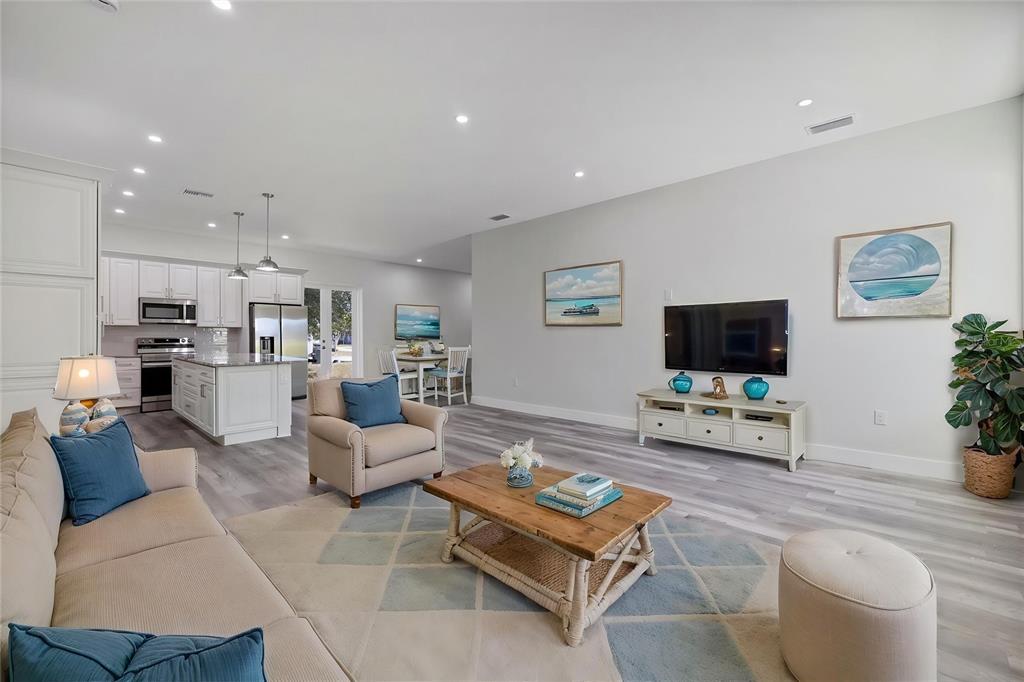 3525 McIntosh Road Sarasota, FL 34232 - Photo 11 of 40 a living room with furniture a flat screen tv and kitchen view