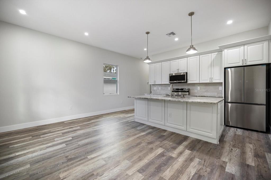 3525 McIntosh Road Sarasota, FL 34232 - Photo 14 of 40 a kitchen with stainless steel appliances a refrigerator sink and microwave