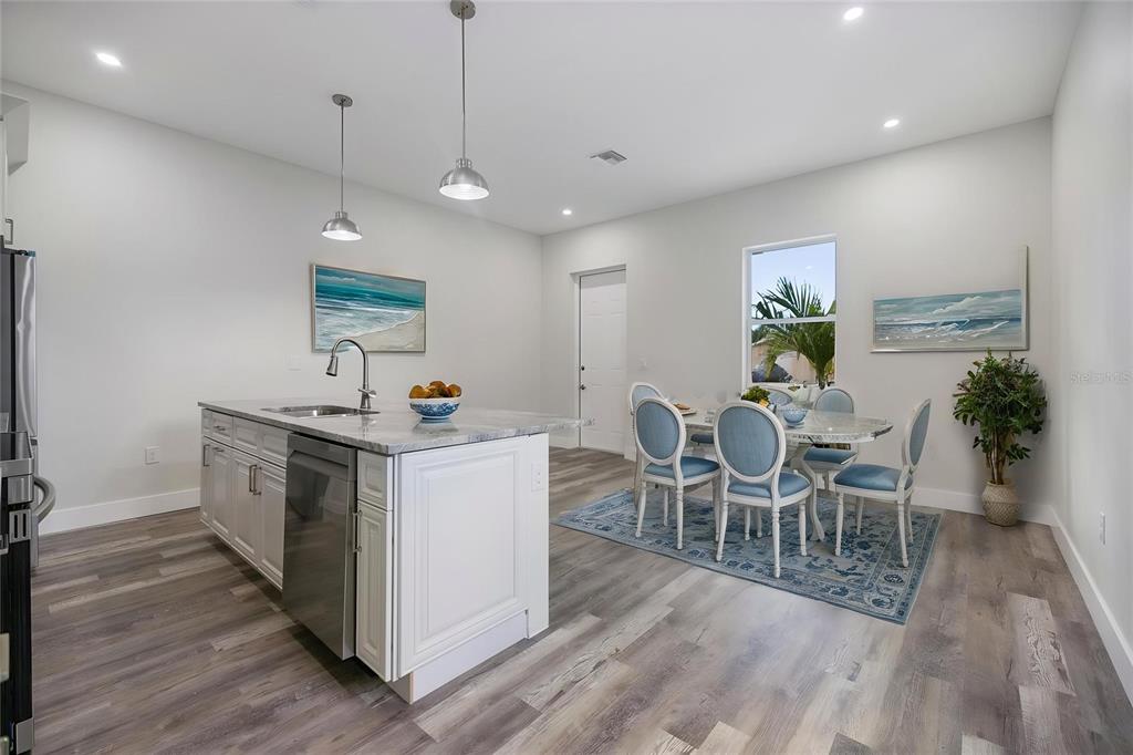 3525 McIntosh Road Sarasota, FL 34232 - Photo 16 of 40 a view of a dining room with furniture window and wooden floor