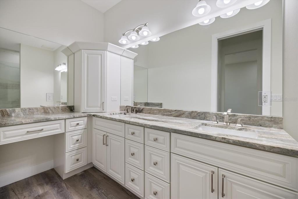 3525 McIntosh Road Sarasota, FL 34232 - Photo 19 of 40 a bathroom with a double vanity sink and a mirror