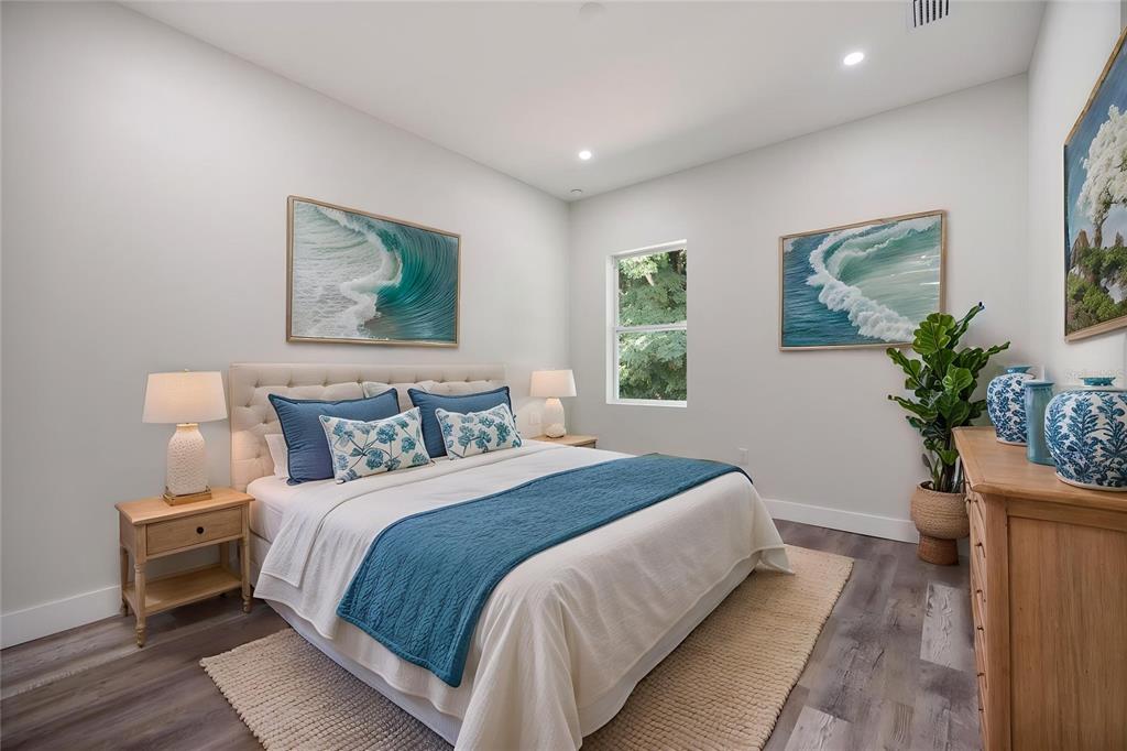 3525 McIntosh Road Sarasota, FL 34232 - Photo 20 of 40 a bedroom with a large bed and a potted plant