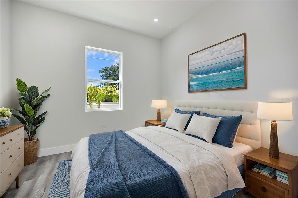 3525 McIntosh Road Sarasota, FL 34232 - Photo 26 of 40 a bedroom with bed and a painting on the wall