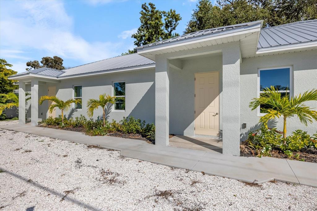 3525 McIntosh Road Sarasota, FL 34232 - Photo 34 of 40 a front view of a house with garden