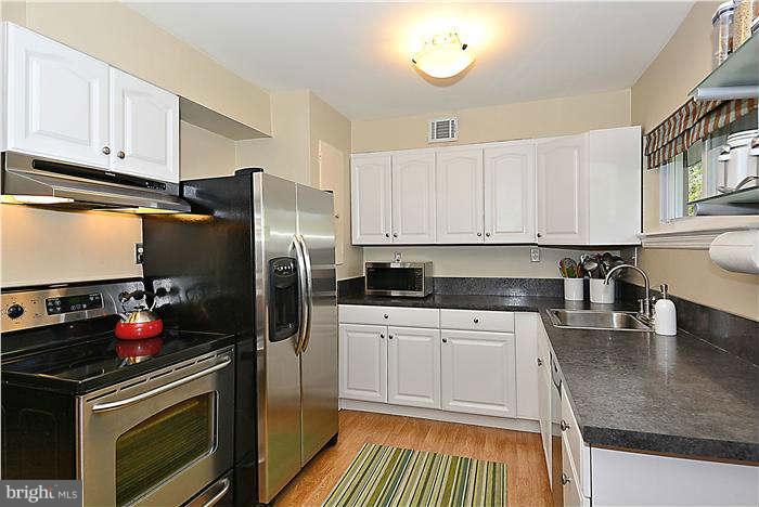 711 Justin Way Silver Spring, MD 20901 - Photo 2 of 22 a kitchen with a sink stove and refrigerator