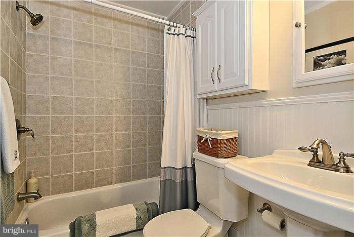 711 Justin Way Silver Spring, MD 20901 - Photo 11 of 22 a bathroom with a sink a toilet and shower