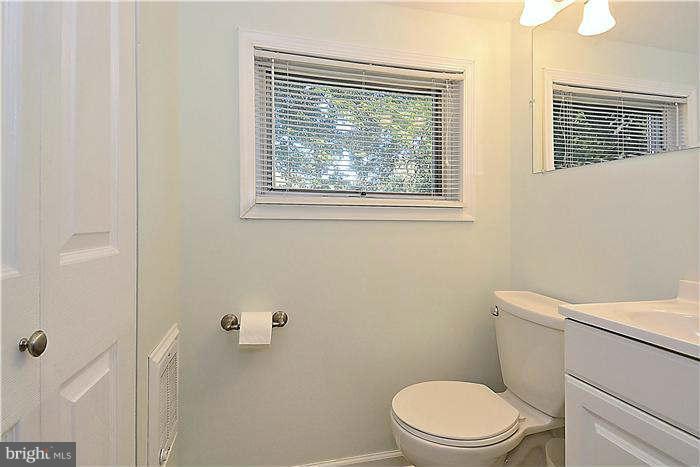 711 Justin Way Silver Spring, MD 20901 - Photo 18 of 22 a white toilet sitting next to a bathroom sink