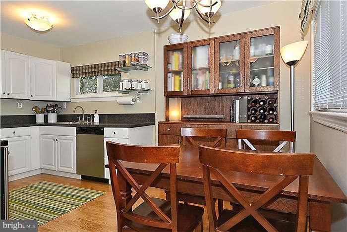711 Justin Way Silver Spring, MD 20901 - Photo 3 of 22 a kitchen with a dining table chairs cabinets and stainless steel appliances