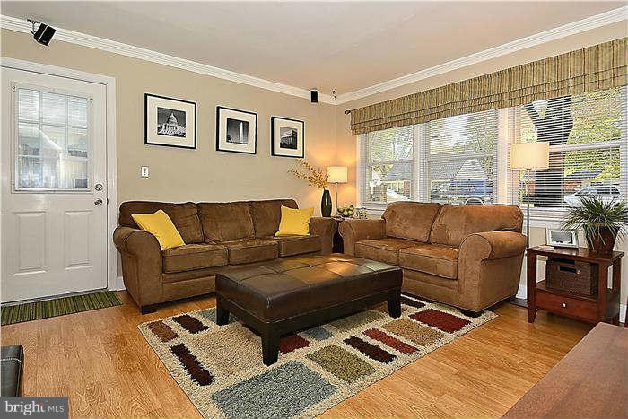711 Justin Way Silver Spring, MD 20901 - Photo 6 of 22 a living room with couches and a night stand with wooden floor