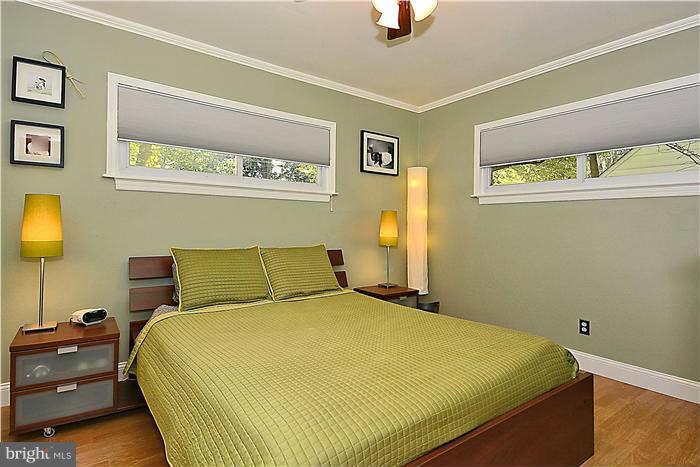 711 Justin Way Silver Spring, MD 20901 - Photo 10 of 22 a bed sitting in a bedroom next to a lamp