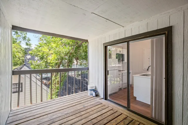 a view of a balcony with wooden floor