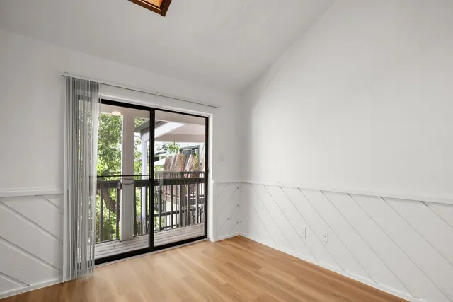 a view of an entryway with wooden floor