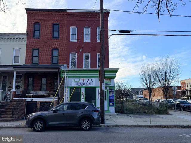 a car parked in front of a brick building