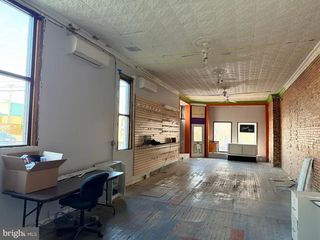 a view of a livingroom with furniture window and wooden floor