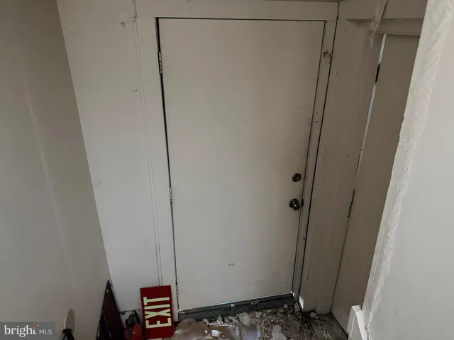 a view of a hallway with wooden floor and entryway