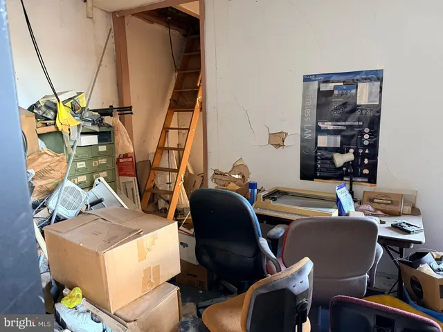 a living room filled with furniture and next to a window