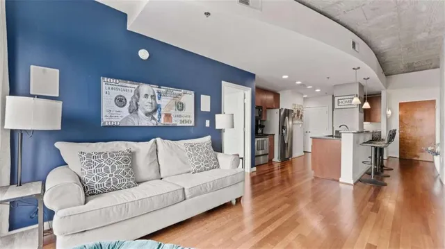 a living room with furniture and kitchen view