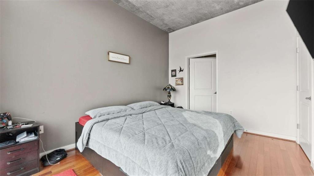 250 Pharr Road Northeast, Unit 712 Atlanta, GA 30305 - Photo 15 of 34 a bedroom with a bed and a desk