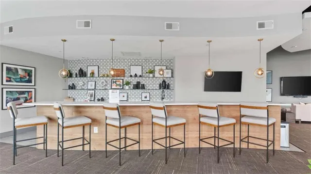 a kitchen with stainless steel appliances kitchen island granite countertop a table and chairs in it