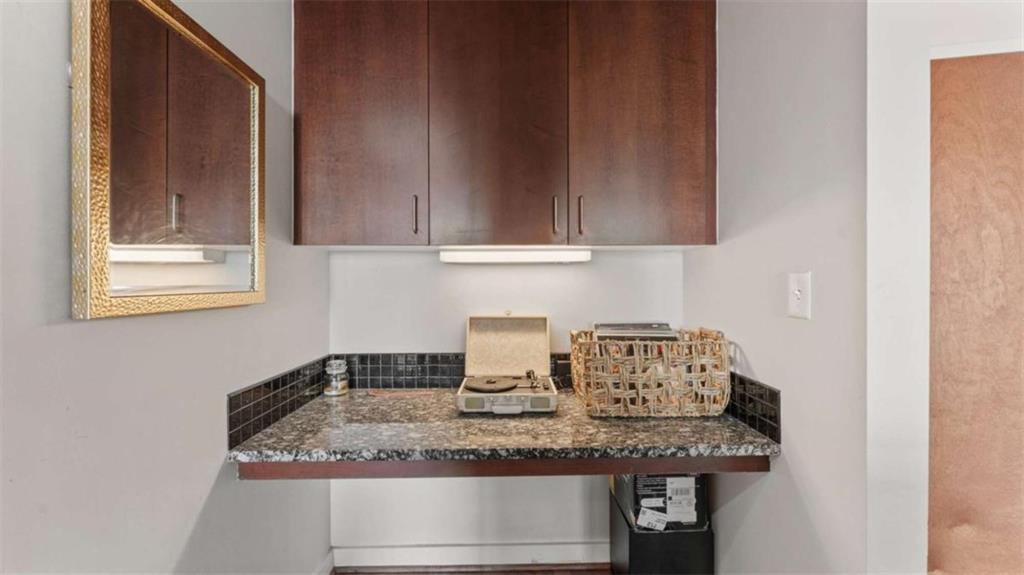 250 Pharr Road Northeast, Unit 712 Atlanta, GA 30305 - Photo 20 of 34 a kitchen with granite countertop a sink and a stove