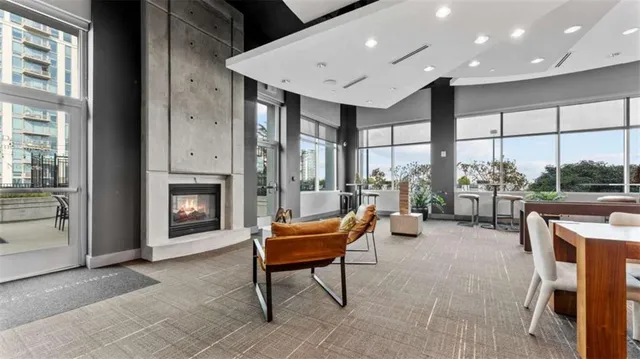 a living room with furniture a fireplace and a table