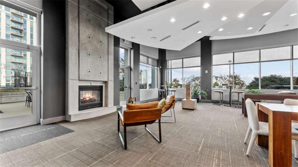 250 Pharr Road Northeast, Unit 712 Atlanta, GA 30305 - Photo 22 of 34 a living room with furniture a fireplace and a table