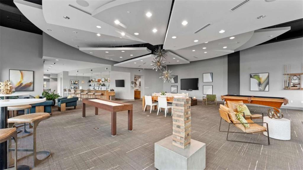 250 Pharr Road Northeast, Unit 712 Atlanta, GA 30305 - Photo 23 of 34 a living room with lots of furniture and a dining table with wooden floor