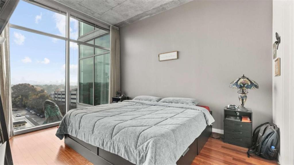 250 Pharr Road Northeast, Unit 712 Atlanta, GA 30305 - Photo 4 of 34 a bedroom with a bed and a view of balcony
