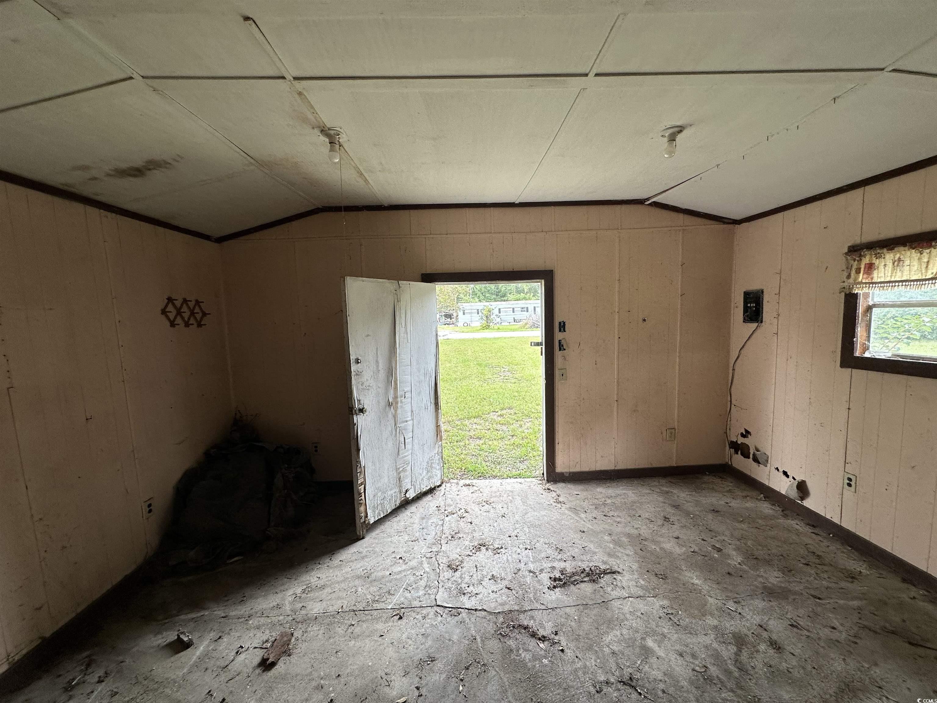 11185 Old Pee Dee Road Hemingway, SC 29554 - Photo 3 of 15 Empty room featuring lofted ceiling and wood walls