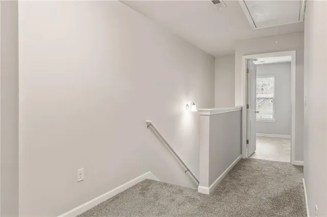 an empty room with fan and entrance