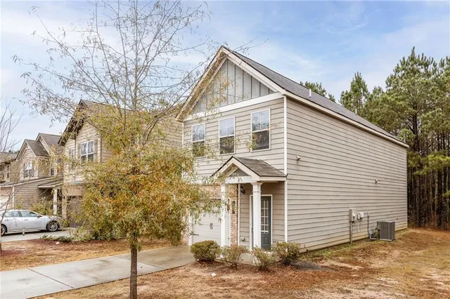 a view of a white house with large windows