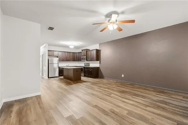 a view of a kitchen with a stove cabinets and wooden floor